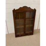 A mahogany glazed display unit with drawers under (H92cm W60cm D21cm)