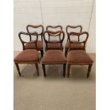 Six balloon back dining chairs on turned legs, two with reeded legs and upholstered seats