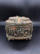 A copper French figural relief oval jewelry or sewing casket on feet by A.B.Paris (H12cm W16cm