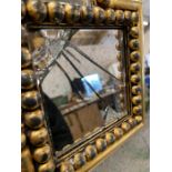 A large contemporary beaded mirror