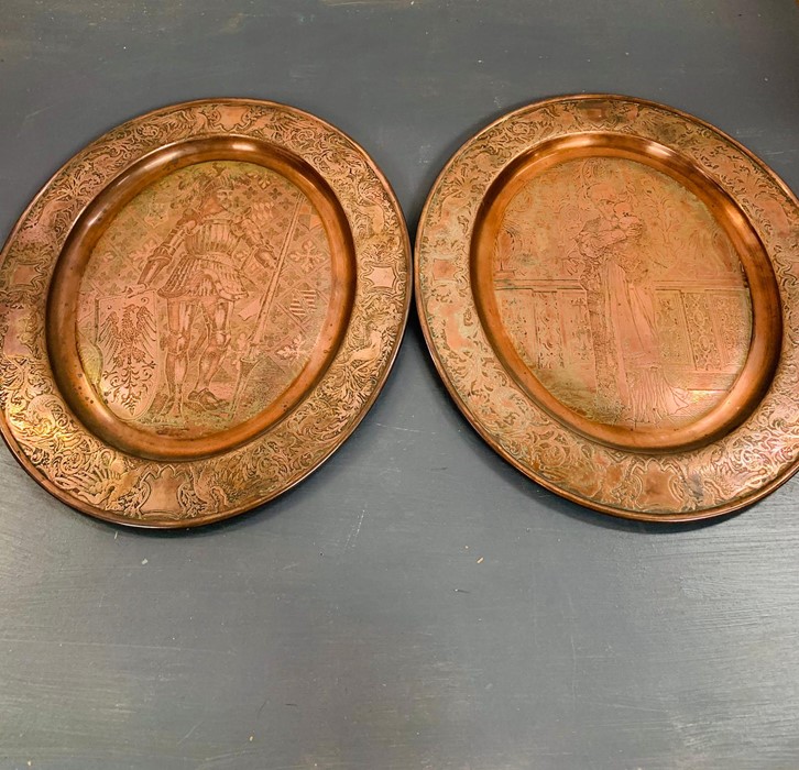 A Pair of Two Copper wall hanging trays with a Medieval Theme.