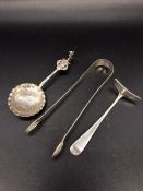 Three silver hallmarked items to include sugar nips, children's food pusher and a spoon.