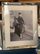 A black and white print of Audrey Hepburn in a mirrored frame