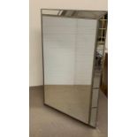 A large mirror with mirror panels to edge