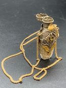 A Scent bottle on a 9 ct gold chain