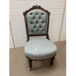 A Victorian framed nursing chair, upholstered button back on castors