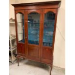 A Mahogany display cabinet with glass shelves and integral lighting with two glass shelves 129 cm