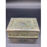 An Indian white metal box with elephant themed design.