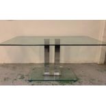 A Glass Dining Table on central metal pillars support 160 cm L x 90 cm W x 76 cm H.