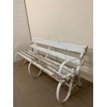 19th century Victorian garden bench with cast iron scrolled sides and wooden slats to seat and back,