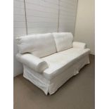 Three seater sofa with white loose covers by Multiyork (H95cm W190cm D94cm)