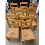Eight oak ladder back chairs with rush seats (H77cm)
