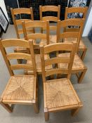 Eight oak ladder back chairs with rush seats (H77cm)