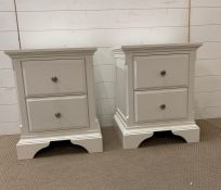 A pair of white bedside tables with silver contemporary handles (H60cm W47cm D39cm)