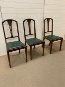 Three mahogany dining chairs with green seat