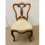 Walnut hall chair on scrolled feet and upholstered seat.