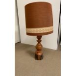 A wooden table lamp with shade