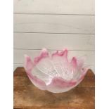 A pink and white waved glass bowl