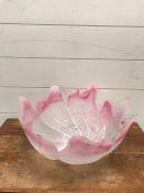 A pink and white waved glass bowl