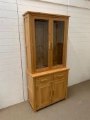 An oak glazed display unit with cupboard under (H195cm W92cm D43cm)