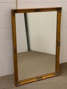An rectangular mirror with decorated frame