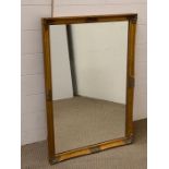 An rectangular mirror with decorated frame