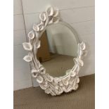 Oval mirror decorated with lilies to frame