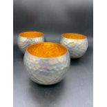 Three metal hammered candle holders (8cm x 10xm)