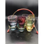 A selection of 50's/60's retro vintage Kitsch Harlequin coloured shot glasses set and wire stand