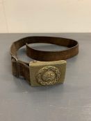 A leather belt with a German belt buckle.