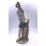 A Nao figurine of a gentleman reading - possibly Shakespeare - And a Roumano porcelain figurine of a