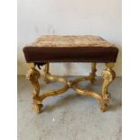 A gilt framed and needle work upholstered stool with scrolled legs and cross stretcher (H53cm
