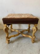 A gilt framed and needle work upholstered stool with scrolled legs and cross stretcher (H53cm
