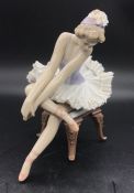 A Lladro figure of a seated Ballerina AFCondition Report One of the legs to the chair has been