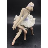 A Lladro figure of a seated Ballerina AFCondition Report One of the legs to the chair has been