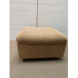 1960's upholstered foot stool on castors