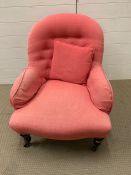 Pink upholstered bedroom chair with button and turn legs