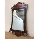 Two gilt oval wall mirrors and one mahogany framed wall mirror