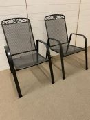 A pair of metal garden chairs