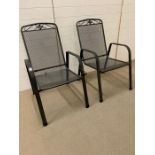 A pair of metal garden chairs