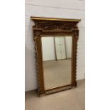 Regency giltwood mirror with scrolling floral decoration to top (H124cm W71cm)