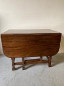 A mahogany gateleg dining table on square legs