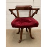 Victorian mahogany rotating desk chair with turned legs and scrolled arms