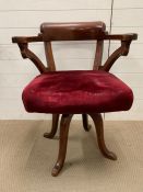 Victorian mahogany rotating desk chair with turned legs and scrolled arms