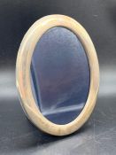 An oval, hallmarked, silver photo frame 12.5 x 16.5cm