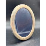 An oval, hallmarked, silver photo frame 12.5 x 16.5cm