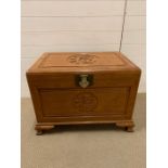 Camphor wood chest with Chinese detail to lid and side. L75cm W50cm H56cm