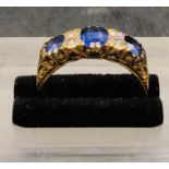 An 18 ct yellow gold three stone Sapphire and Diamond Ring