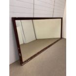 A large haberdashery shop mirror in a wooden frame (129cm x 294cm)