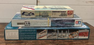 A selection of three model kits to include Revell Light Cruiser, Tamiya Battle Ship Yamato and